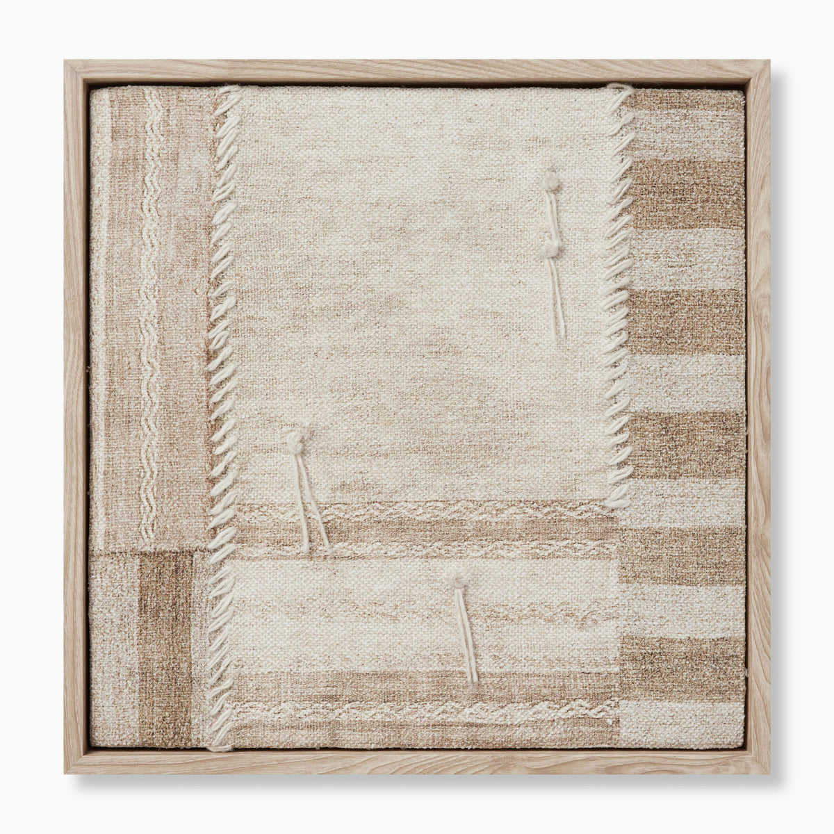 Patchwork textile wall art with intersecting woven panels, fringed edges, and stitched details in warm neutral, earthy hues.