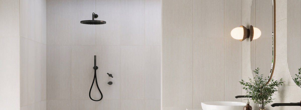 Modern bathroom featuring vertical white textured tiles, a sleek black shower head, and a globe wall light