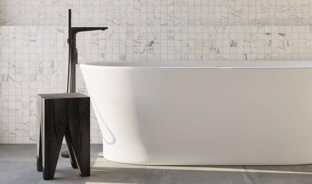 Minimalist bathroom with white marbled mosaic tiles and sleek freestanding tub