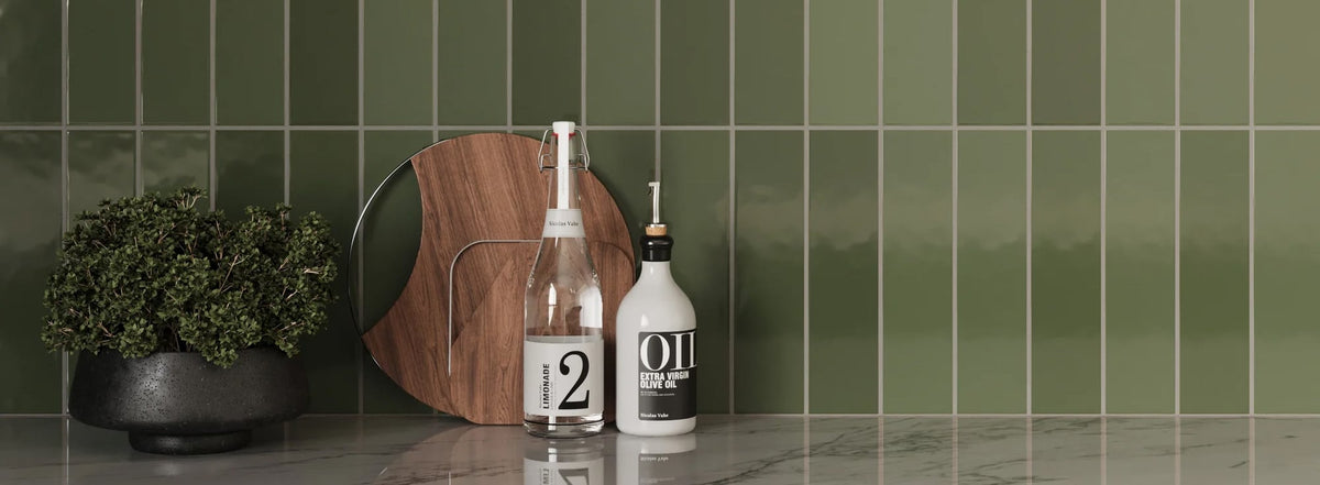 Sleek green tile wall in a refreshing hue brings a natural, calming essence to a modern kitchen setting