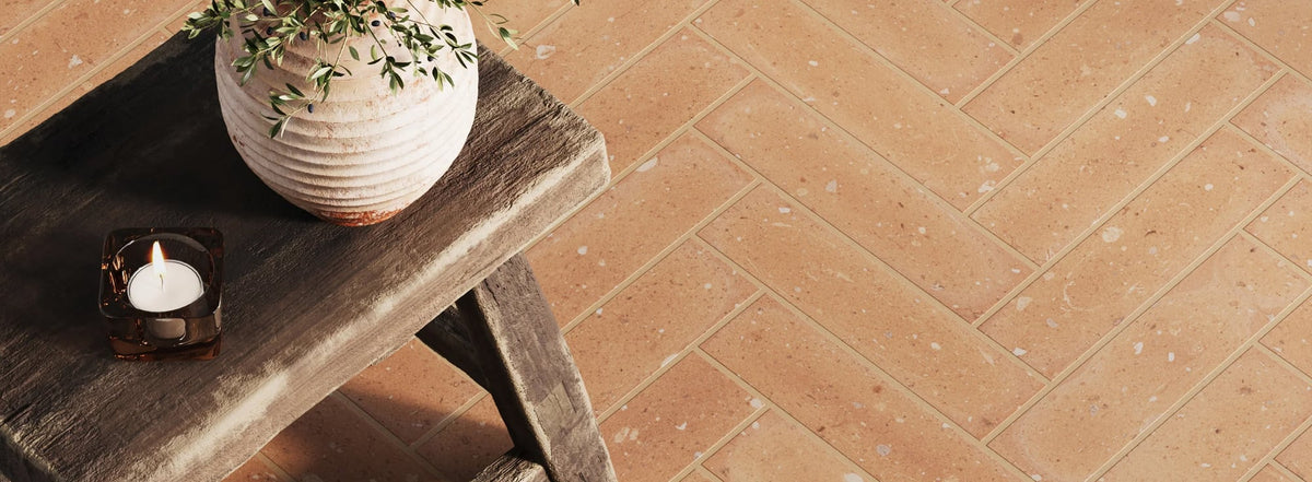 Terracotta orange tile flooring brings warmth and rustic charm to this cozy, inviting space