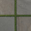 Bowden 24x24 Grip Porcelain 2CM Paver in Multicolor, showcasing earthy tones and lush green grass accents for a natural outdoor aesthetic.