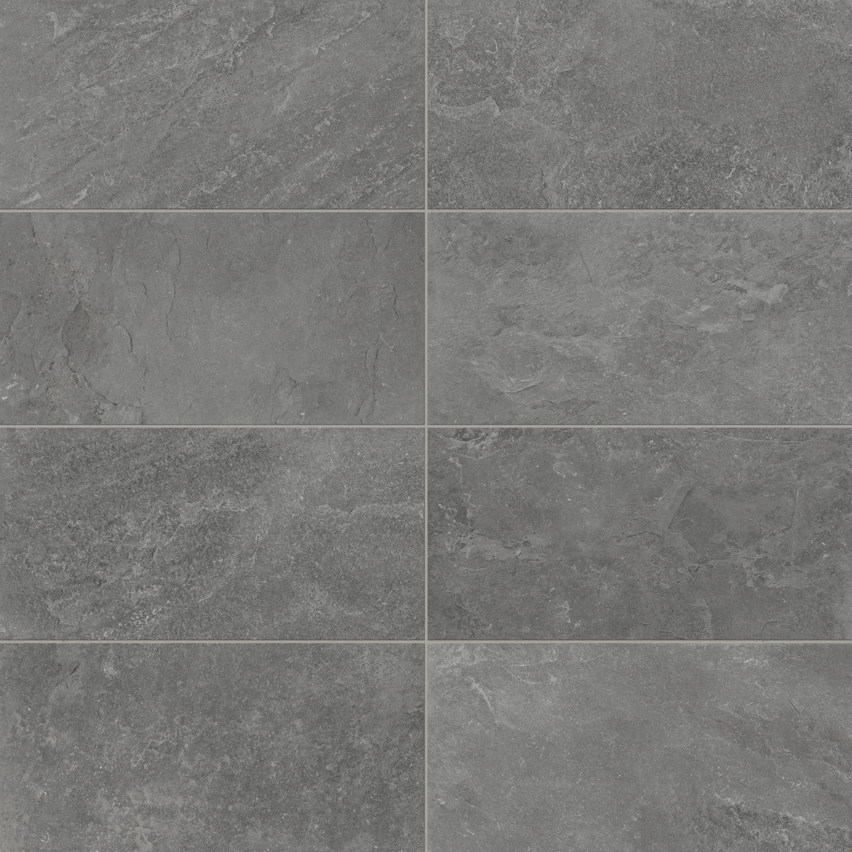 Porcelain tiles in a 12x24 format featuring a matte charcoal finish, showcasing natural stone-inspired textures for contemporary indoor or outdoor designs.