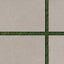 Close-up of Wren 24x36 grip porcelain 2cm paver tiles in dune, showcasing a natural beige tone with precise placement on lush green grass for modern outdoor designs.