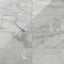 Astrid 12x24 polished porcelain tile in Slate, showcasing a sleek marble-like pattern with shades of gray and subtle veining.