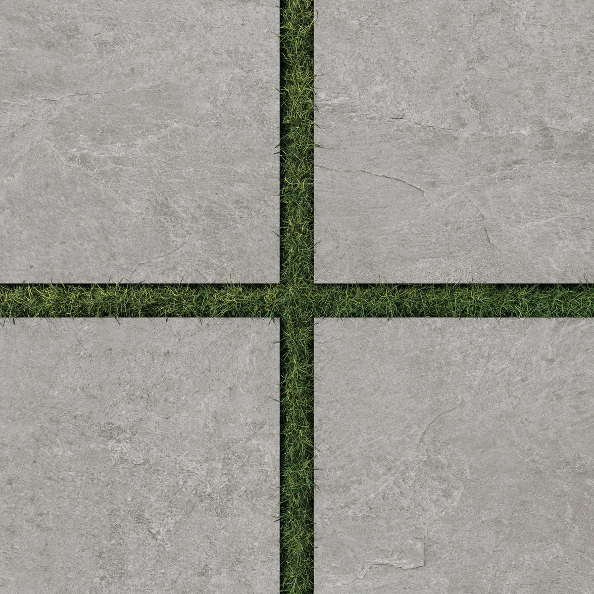 Dawson 24x24 Grip Porcelain 2cm Paver Tile in Ash, arranged with green grass joints, highlighting its natural stone texture for outdoor spaces.