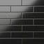 Polly Black 3x10 satin ceramic tiles showcase a sleek, matte finish with deep black tones, perfect for adding bold sophistication to contemporary spaces.