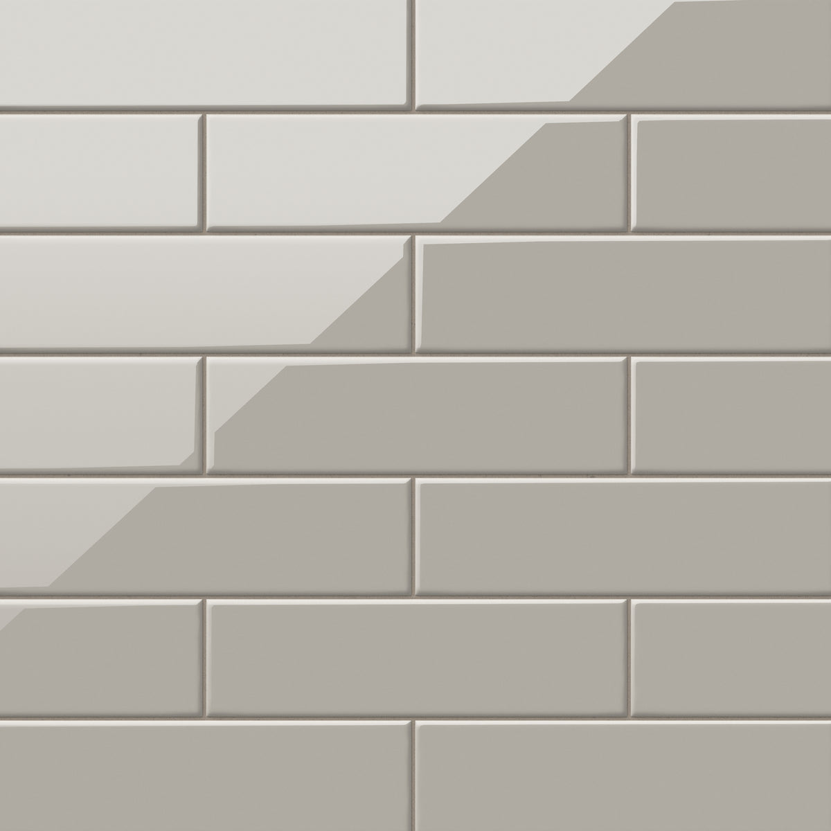 Polly Grey 3x10 glossy ceramic tiles combine a sleek reflective surface with a neutral tone, perfect for modern backsplashes or sophisticated feature walls.