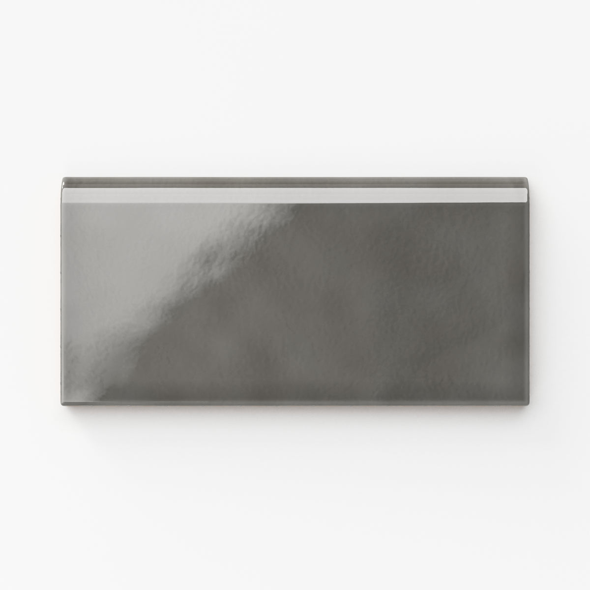 Mikayla ceramic bullnose tile in a smoky gray hue with a subtle glossy finish, perfect for sophisticated modern spaces