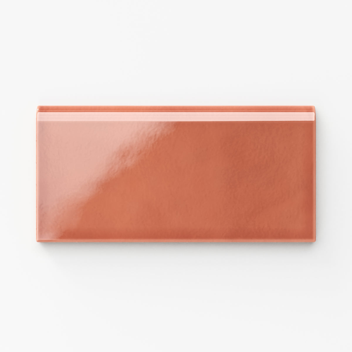 Glossy Mikayla ceramic bullnose tile in a vibrant orange-pink tone, ideal for adding warmth and character to edges and trims