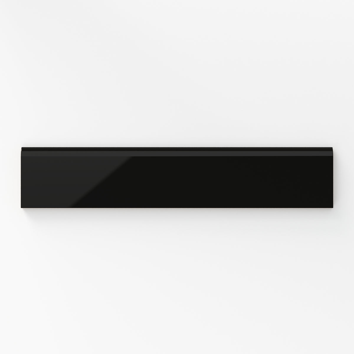 Glossy black bullnose tile in a deep midnight shade, offering a sleek and dramatic finish for modern interiors.