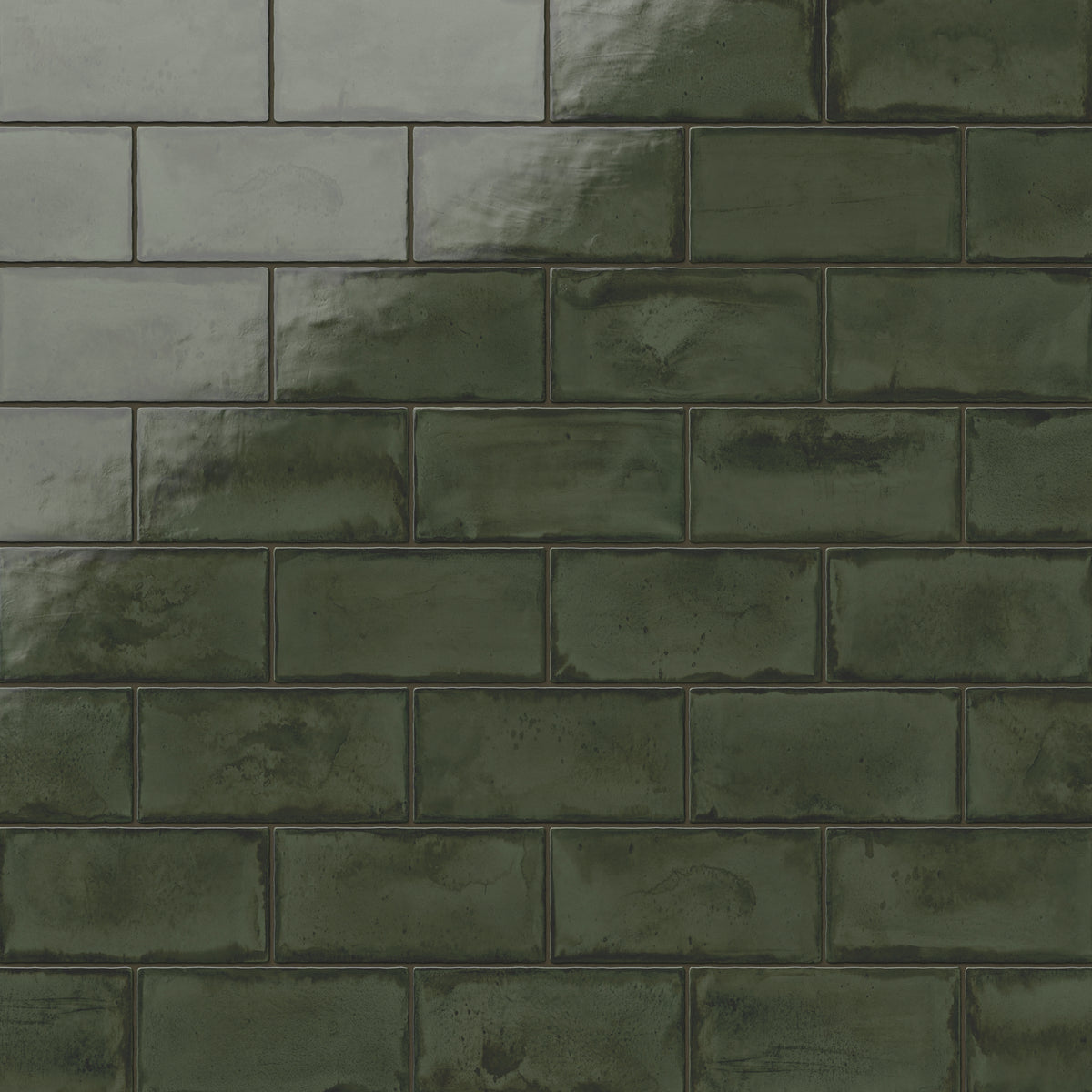 Deep moss-green glossy ceramic subway tiles in a 3x6 format with subtle tonal variations, offering a rich handmade finish for walls or backsplashes