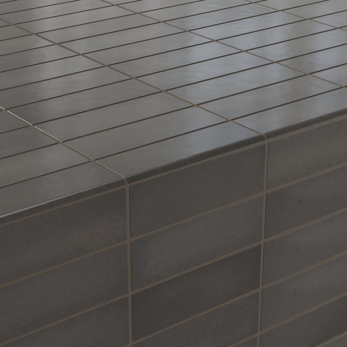 Elegant dark grayish-brown bullnose tiles with a smooth matte finish, seamlessly applied to create a modern corner design