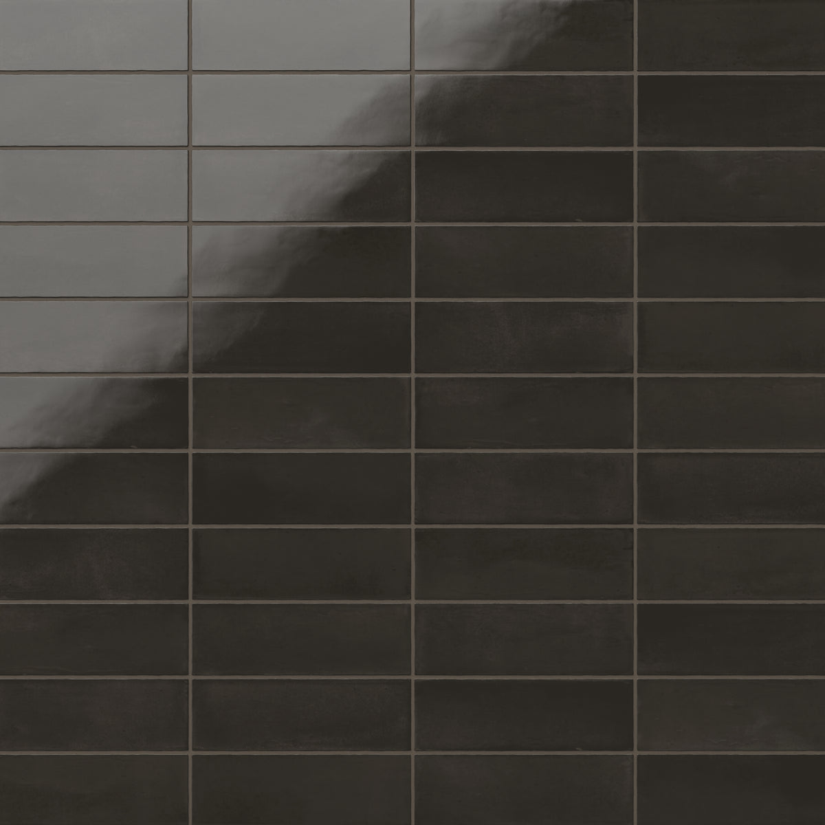 A 2x6 porcelain subway tile in deep black, featuring a glossy finish, and a clean stacked layout with fine grout lines.