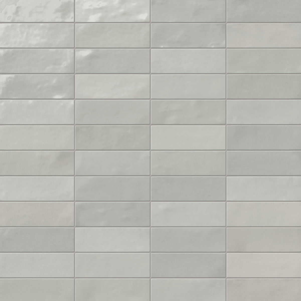 A 2x6.3 ceramic subway tile in light gray, featuring a glossy finish, and a clean stacked layout with fine grout lines.