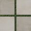 Checkerboard pattern of matte 24x24 concrete tiles in putty and chalk colors with green grass visible between the square gaps.
