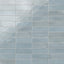 Glossy subway tiles in soft pastel blue tones with subtle shade variations and an artisan-like finish.