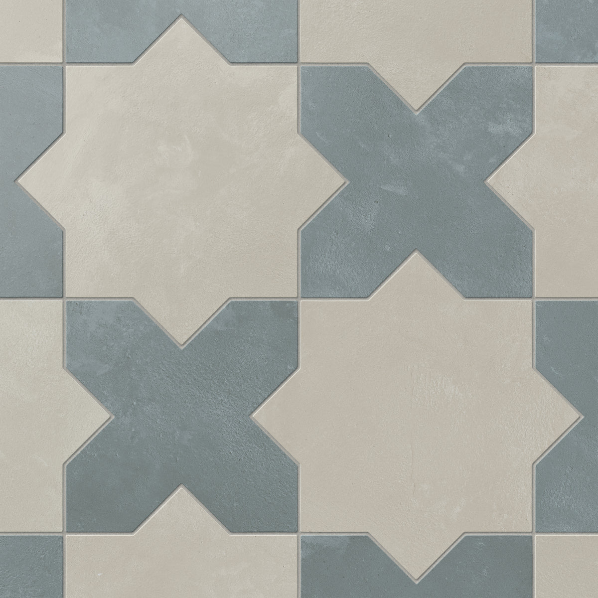 Alternating star and cross patterns appear in earth-drawn hues of light gray and blue, with a matte porcelain finish and softly aged terracotta look that suits warm, diffused lighting.
