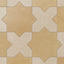 Star and cross shapes move naturally across this porcelain tile, blending yellow-orange and warm beige with a powdery matte finish and subtle cement-plaster texture inspired by handmade terracotta.