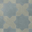 Star and cross shapes move easily across the surface, blending blue and muted sage green with a matte, powdery finish and subtle cement-plaster texture inspired by handmade terracotta.
