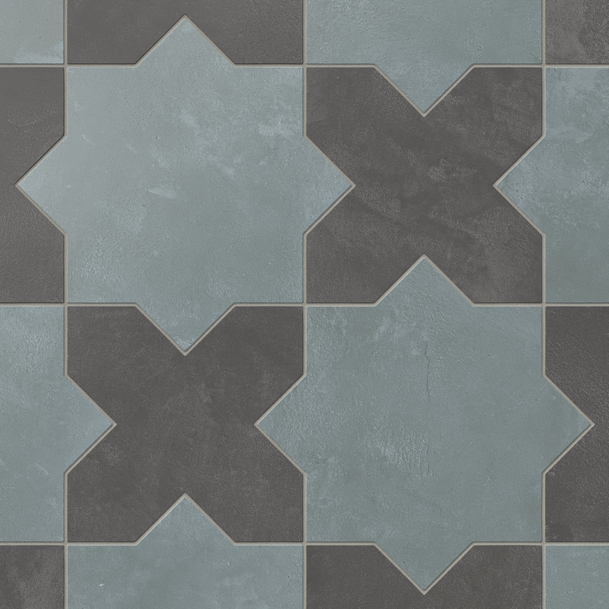 This matte porcelain tile pairs star and cross forms in alternating earth-drawn hues of blue and dark gray, softened by subtle cement-plaster texture and a powdery glaze inspired by handmade terracotta.