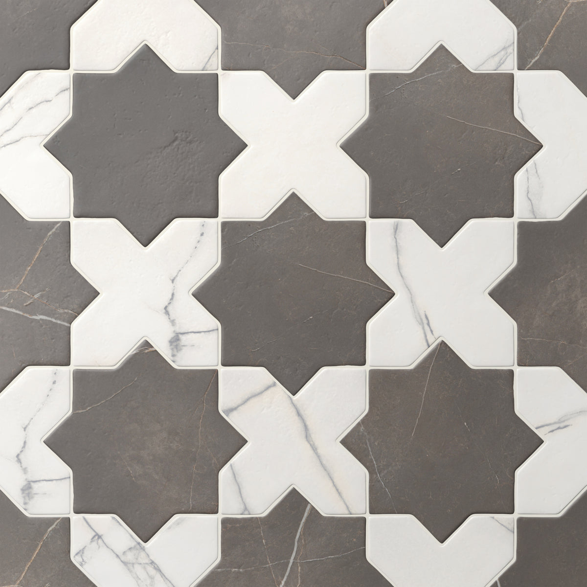 Dark gray and white Aslan 6x12 porcelain tiles in star and cross shapes show gentle veining across a matte finish and softened edges, perfect for kitchens or accent walls.