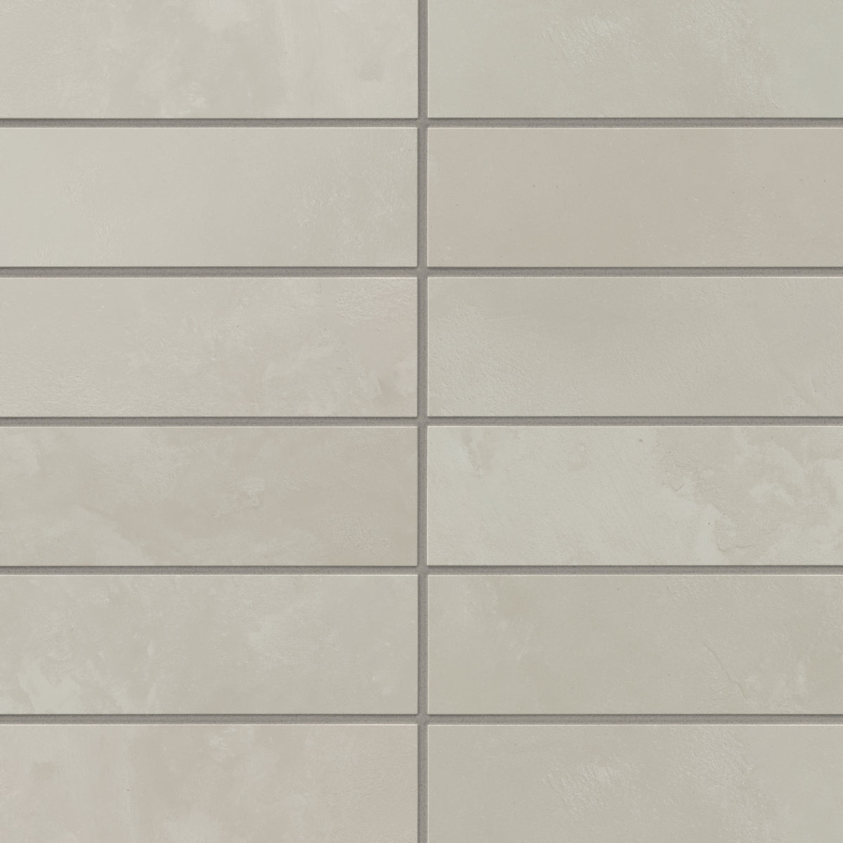 2x6 porcelain subway tiles in light gray blend quiet, earth-drawn shading with a powdery matte finish, giving walls a calm, polished look that suits kitchens and bath spaces.