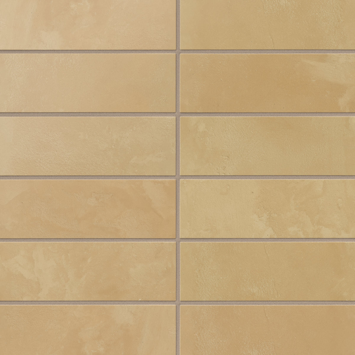 Yellow-orange 2x6 porcelain subway tiles carry gentle, earth-drawn variation and a powdery matte surface, laying out smoothly for backsplashes and interior walls.