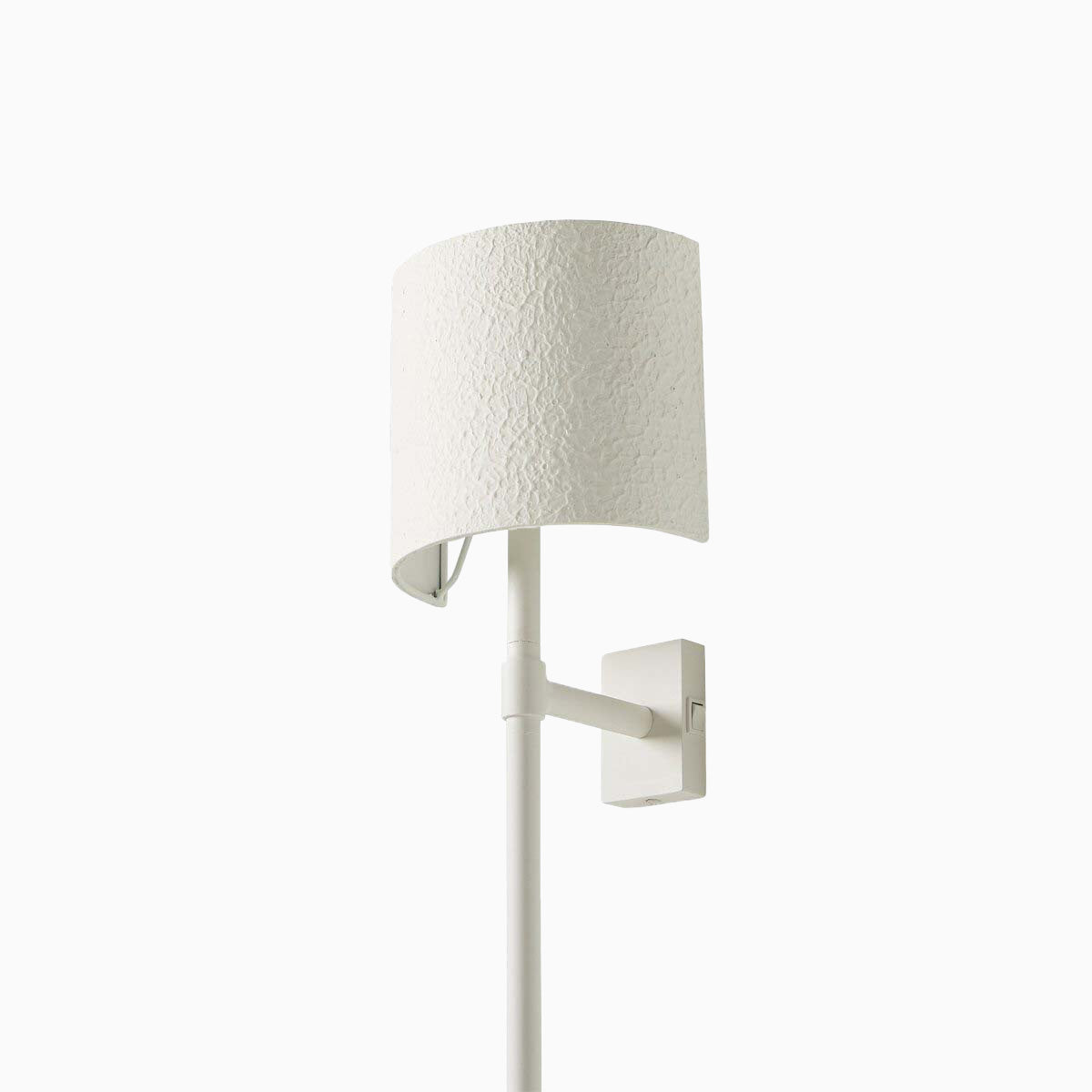 Textured matte white plaster wall sconce with a minimalist semi-cylindrical shade and seamless silhouette.