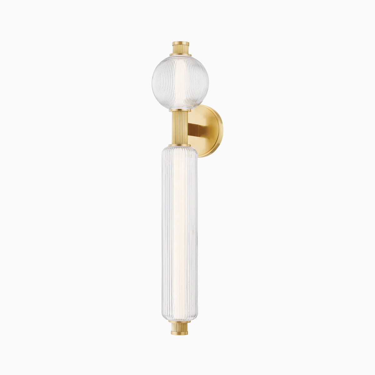 Vertical wall sconce with ribbed glass globe and cylindrical shade, mounted on a round vintage brass base with decorative end caps.