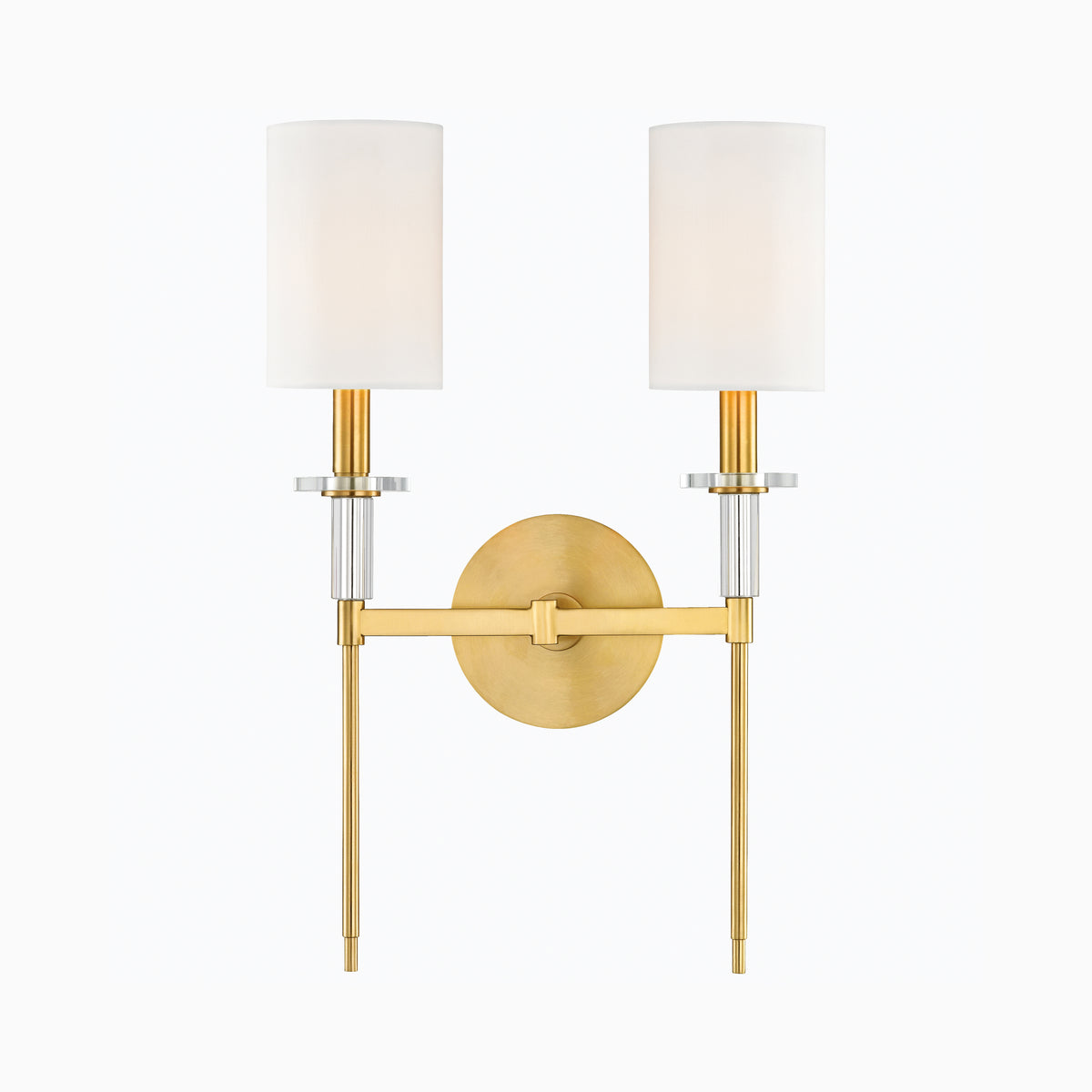 Aged brass double wall sconce with two white cylindrical shades, crystal accents, and round backplate for an elegant modern lighting accent.