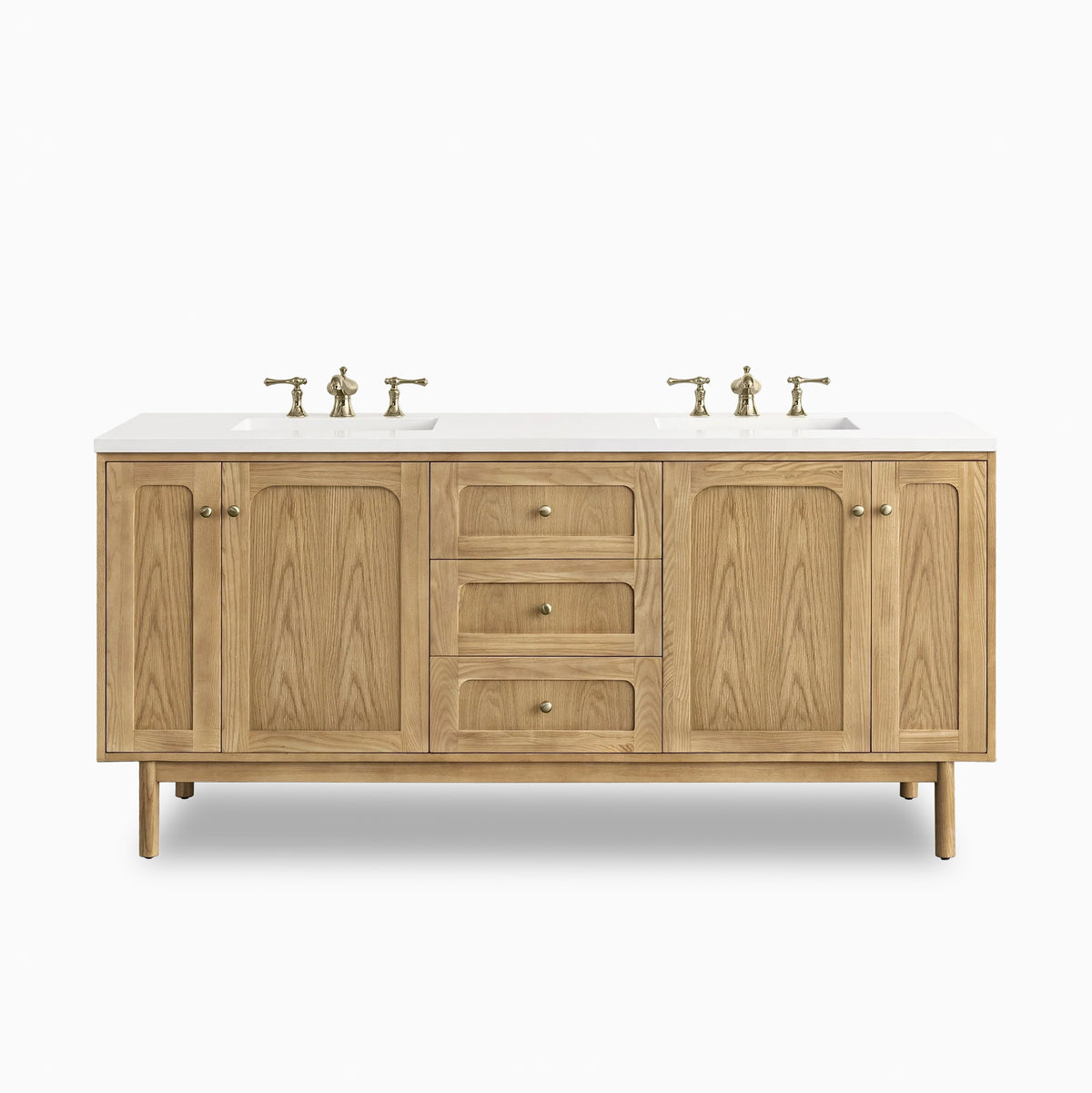 Abigail 72" double vanity in light natural oak with arched panel doors and soft brass hardware, topped with white quartz countertop.