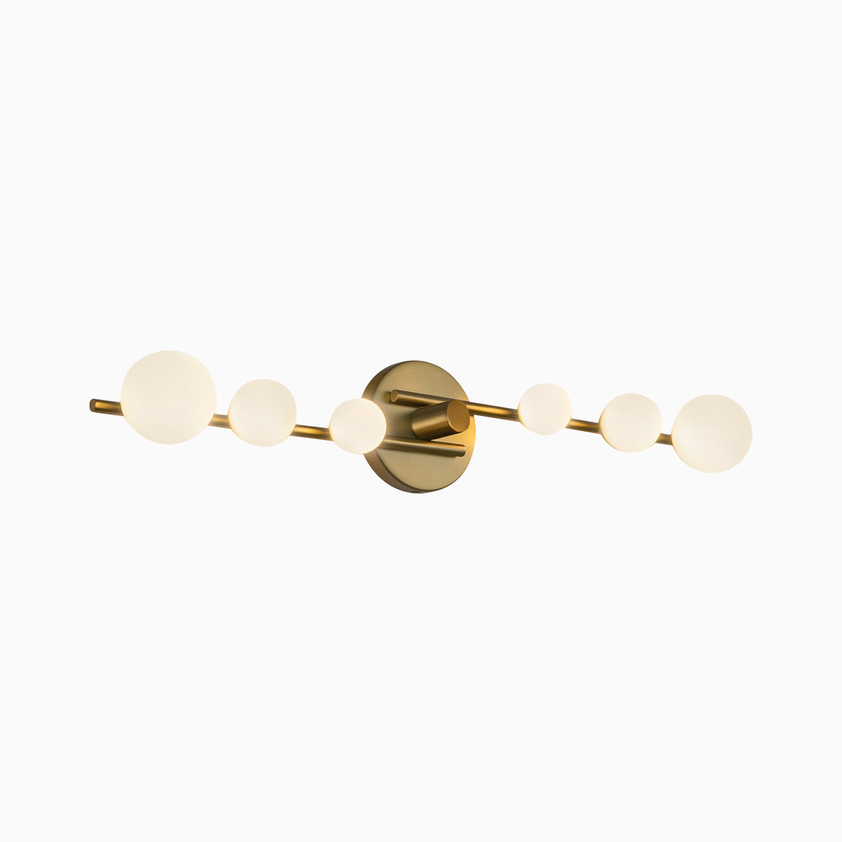 Modern LED vanity light in brushed gold with a linear bar and six frosted glass globe bulbs, creating warm even illumination suited for contemporary bathroom spaces.