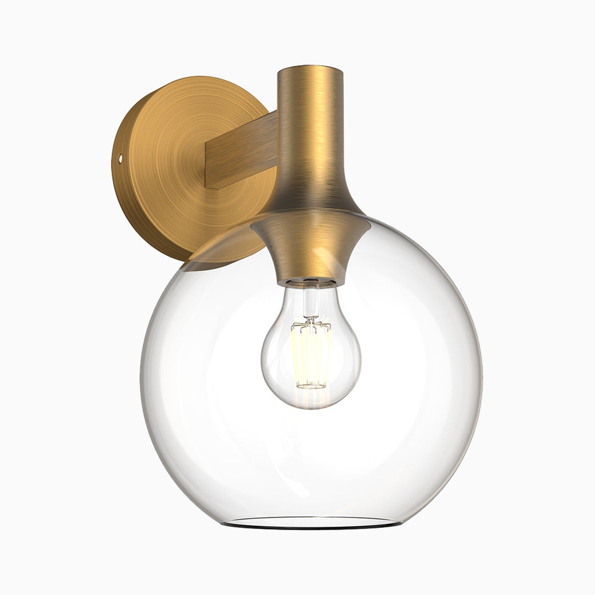 Wall sconce with clear glass globe shade and brushed brass backplate and arm.