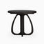 Round black wood dining table with a smooth tabletop and sculptural curved pedestal base, offering a bold, modern statement with organic form.