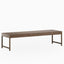 In a soft matte walnut brown, the Thibault Walnut Dining Table, sized at 120" × 36", features a long rectangular top with visible wood grain and a light, minimalist base.