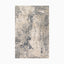 Power loomed area rug made of polypropylene and polyester, featuring a distressed design in soft beige, ivory, and deep blue tones, creating a modern yet vintage-inspired look.