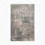 Power loomed area rug made of polypropylene and polyester, featuring a distressed, textured design in muted blue, gray, and beige tones, creating a traditional look.