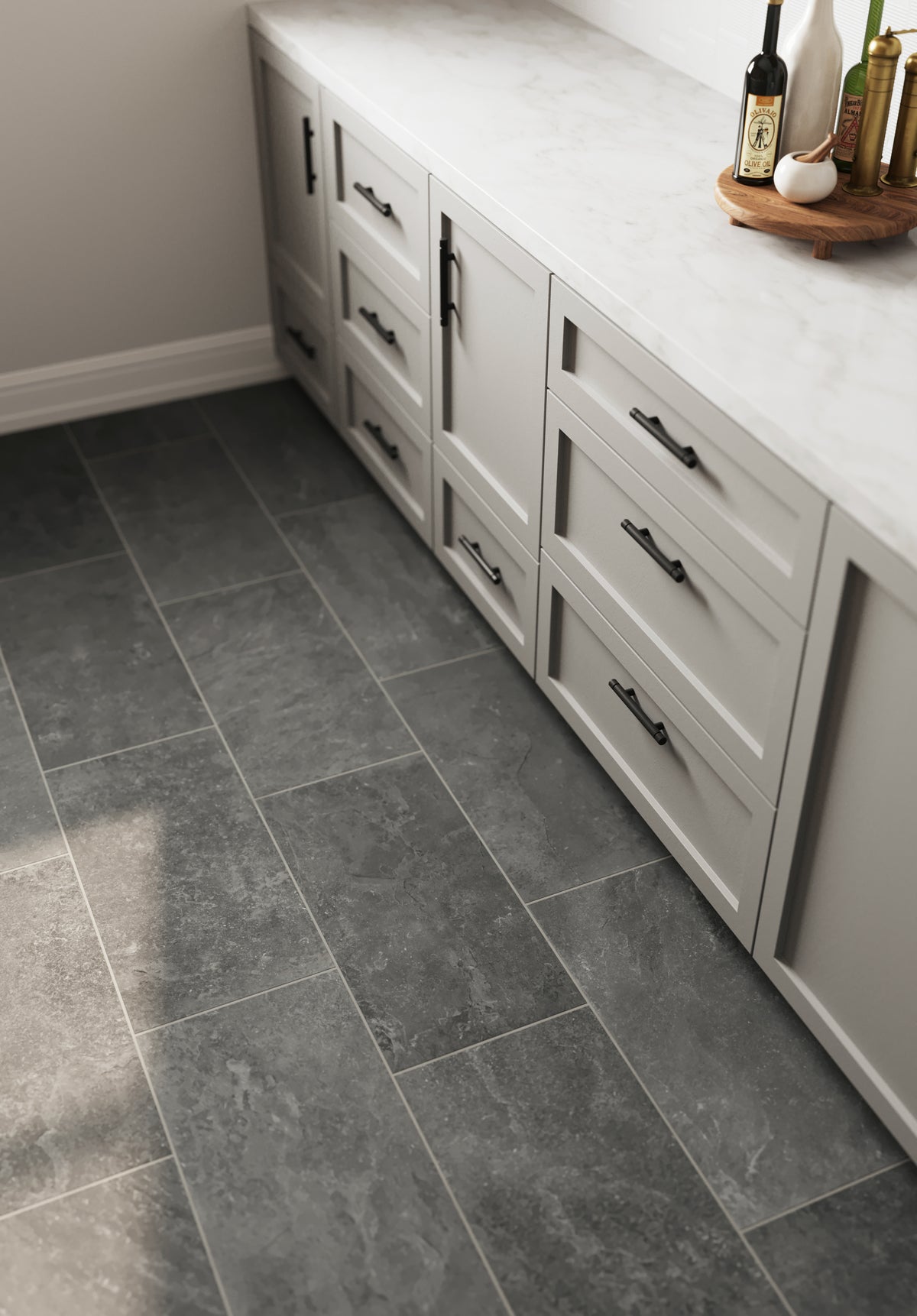 Modern kitchen featuring Wren 12x24 matte porcelain tiles in charcoal finish, paired with sleek light-gray cabinetry and a marble countertop for a sophisticated design.