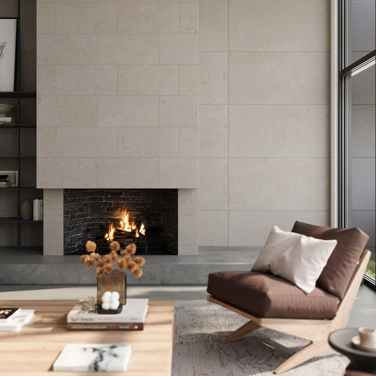 Modern living room featuring Wren 24x48 chiseled tiles in dune, complementing a minimalist fireplace and cozy furnishings in a serene, light-filled space.
