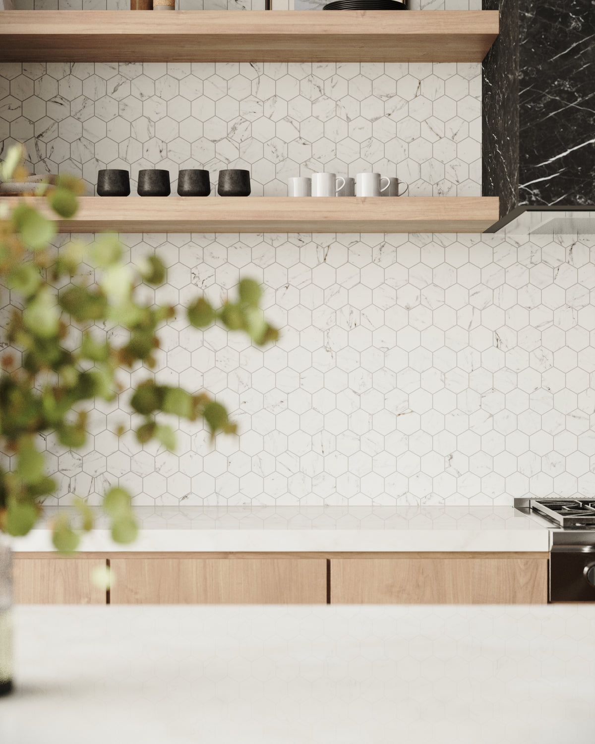 Hexagonal matte white tiles with subtle Carrara-inspired veining create a minimalist backsplash, beautifully complemented by natural wood shelving and bold black accents.