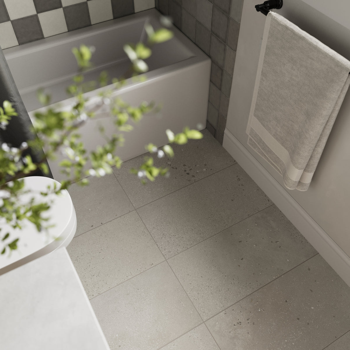 Close-up view of Sloane Sandstone 12x24 matte porcelain tiles, showcasing their warm beige tone and speckled texture, perfect for creating an inviting and serene bathroom space.