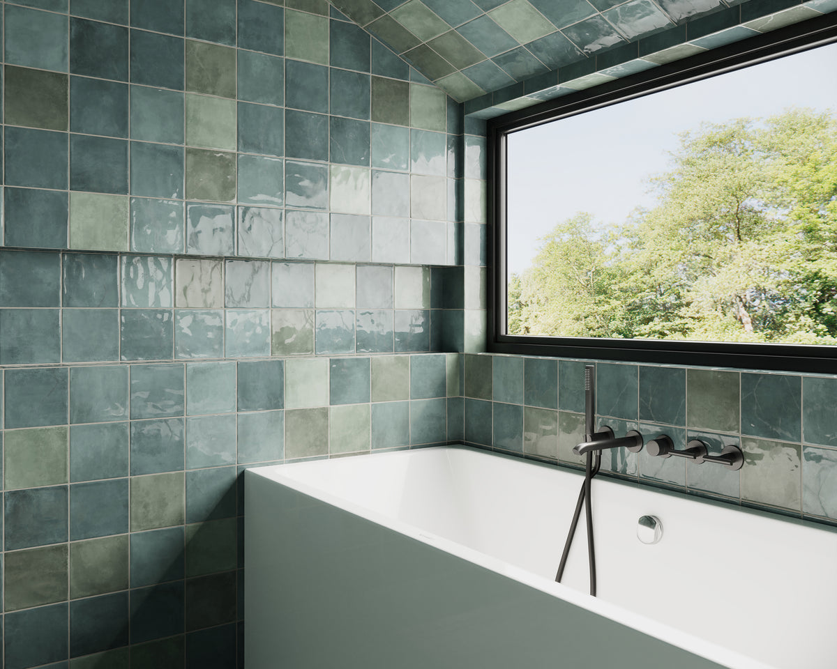 Bathroom featuring Lilah Opal 6x6 glossy tiles in teal and green tones, with a modern soaking tub and a large window with a scenic view.