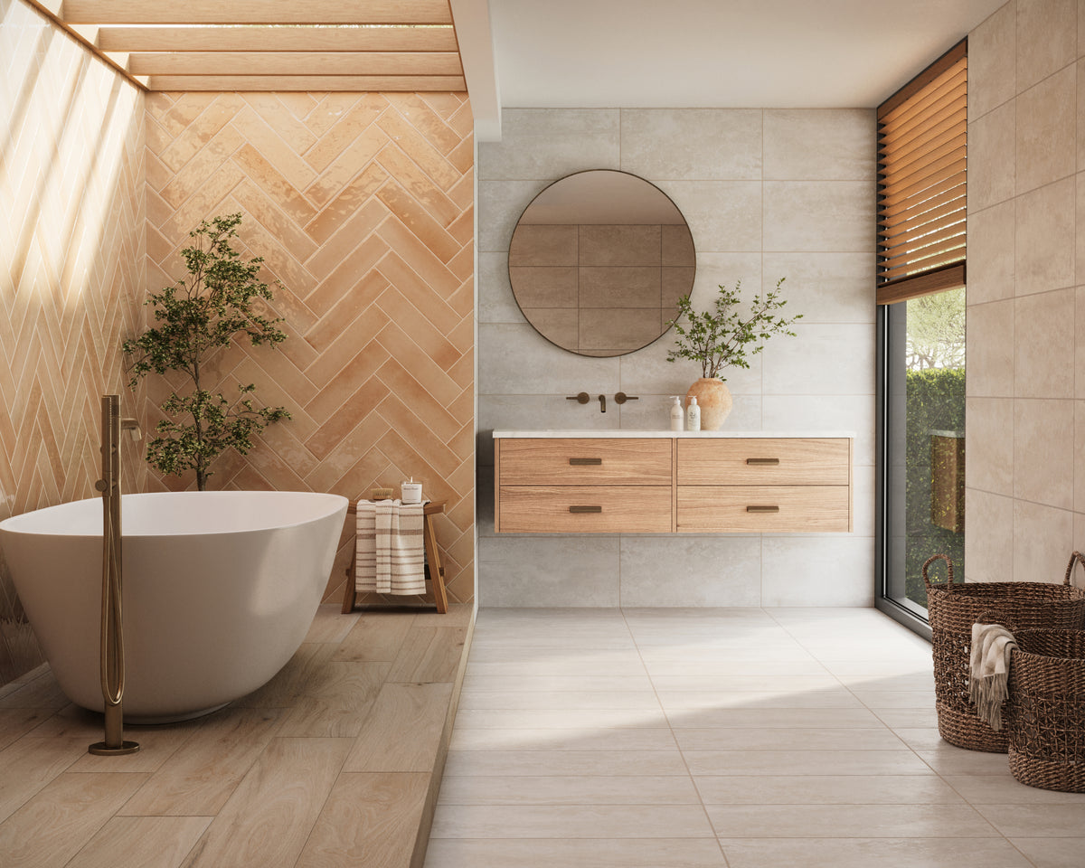 Orange glossy subway tiles in a herringbone pattern create a warm accent wall, paired with natural wood finishes and a freestanding tub for a serene bathroom retreat.