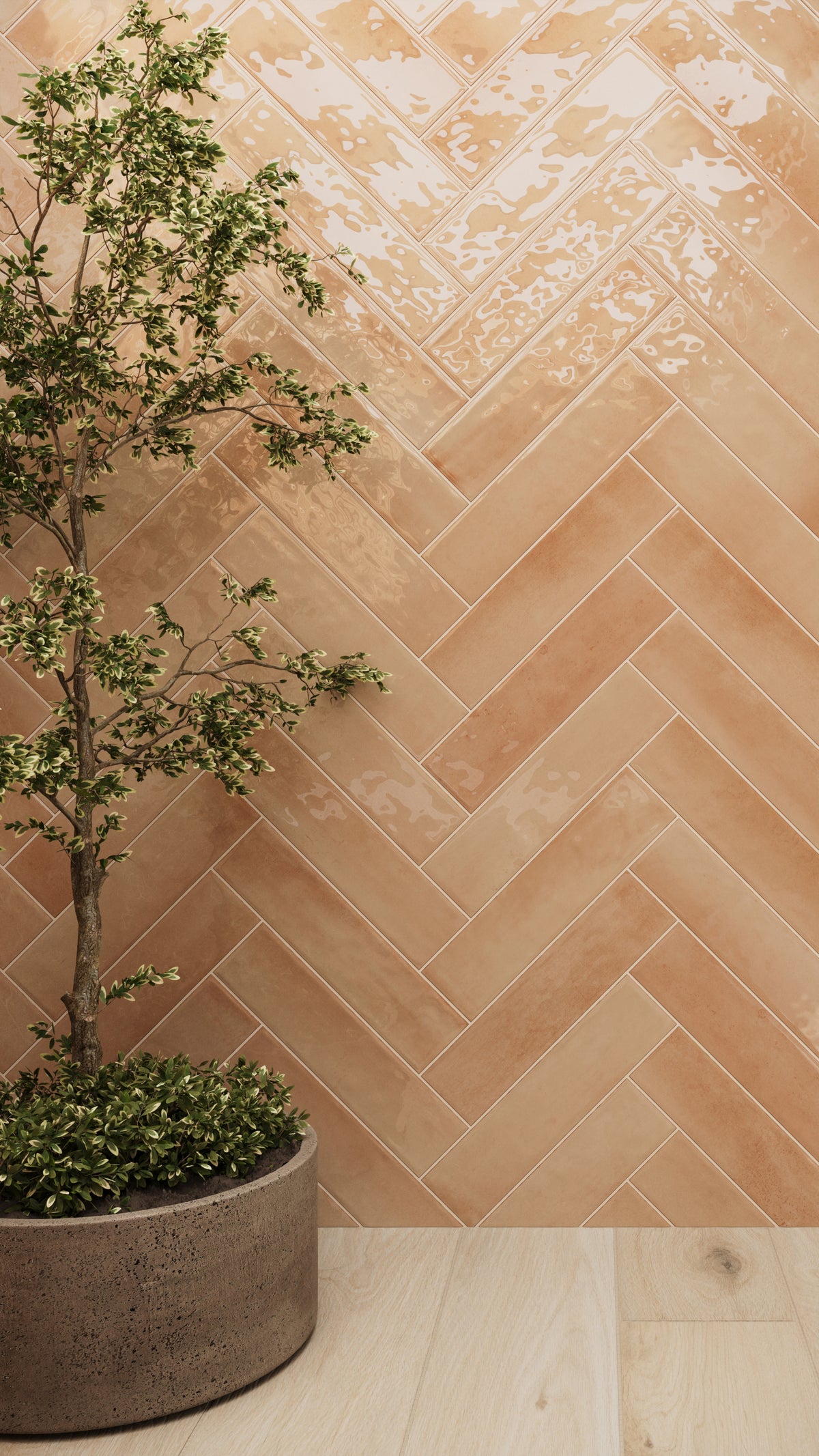 Glossy orange subway tiles in a herringbone layout add warmth and texture, complemented by light wood flooring and vibrant greenery.