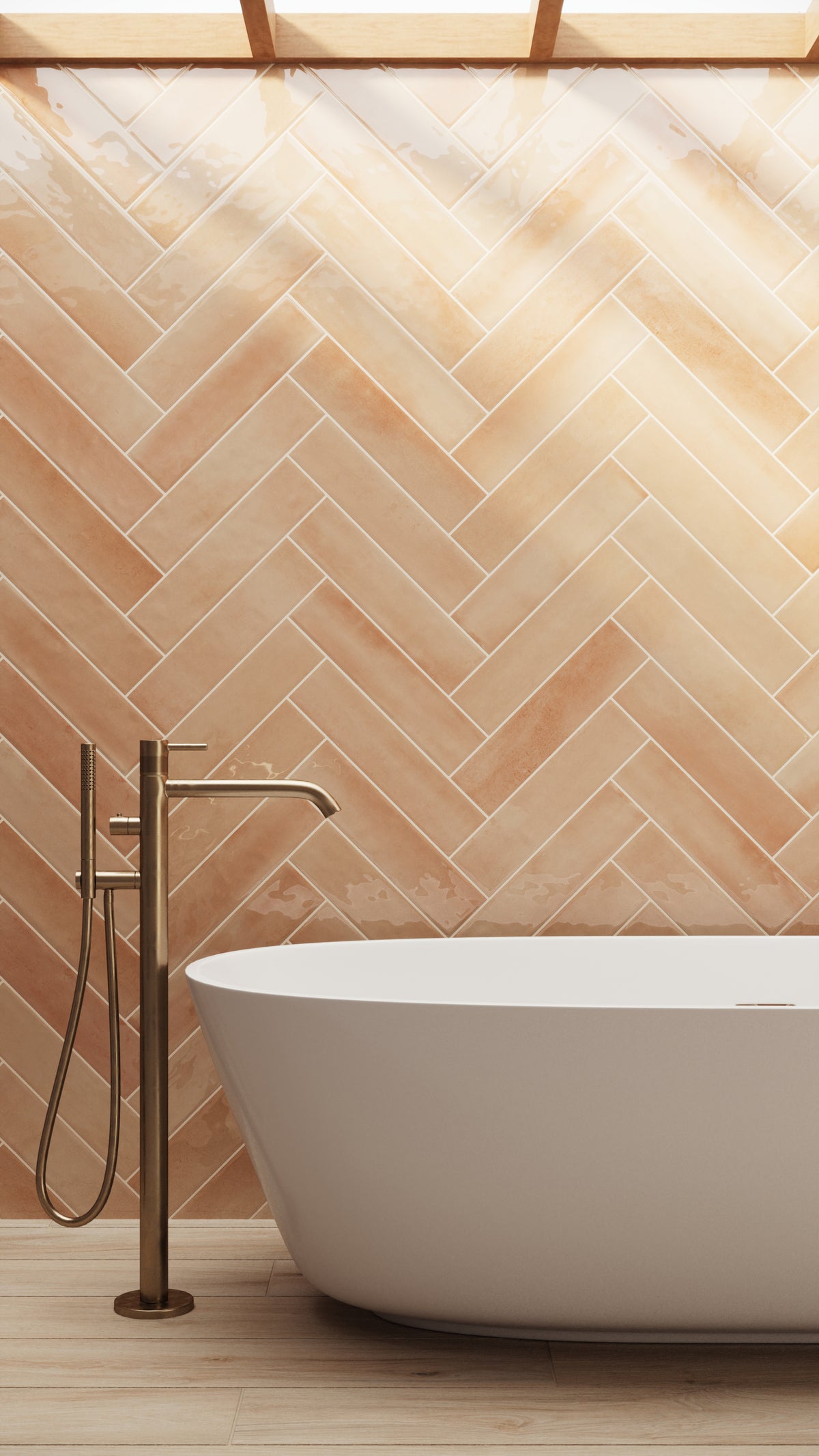 Orange glossy subway tiles in a herringbone pattern bring warmth and elegance, complementing a freestanding tub and brass fixtures in a spa-like retreat.
