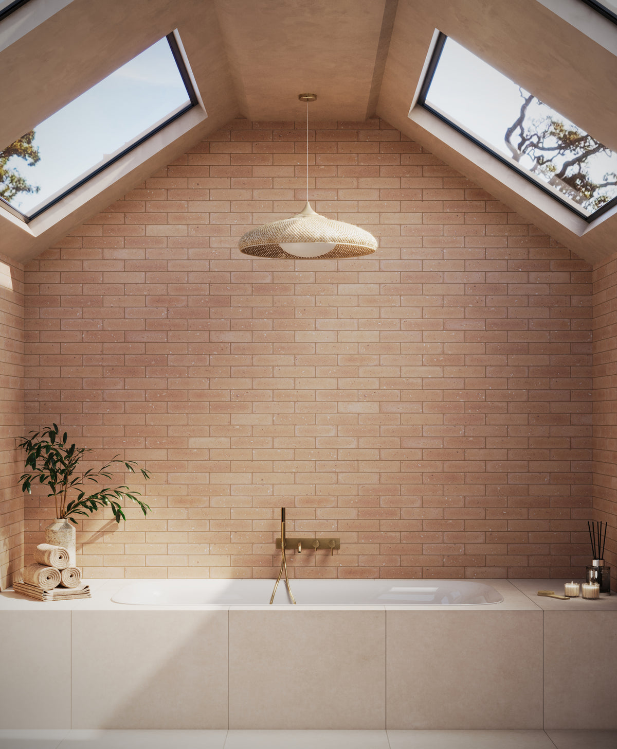 A tranquil bathroom with skylights illuminating a soaking tub featuring Wyatt 32x32 matte porcelain tile in Dune, gold fixtures, and natural accents.