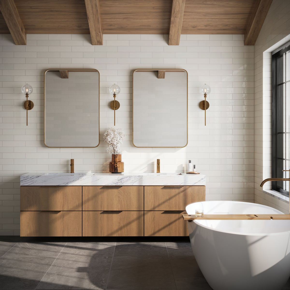Elegant bathroom with Teagan 3x12 glossy ceramic tiles in pearl white, complemented by wood accents, brass fixtures, and a freestanding tub.