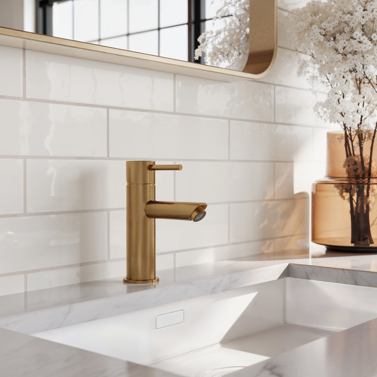 Close-up of a modern bathroom sink with brass faucet, set against Teagan 3x12 glossy ceramic tiles in pearl white for a refined, luminous finish.