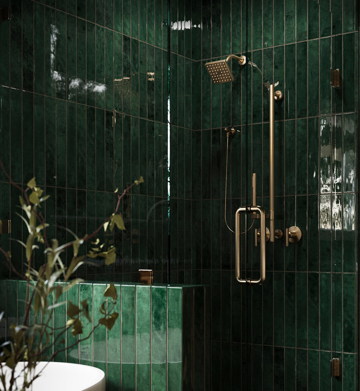Contemporary bathroom featuring Jaden Hunter 2.5x16 glossy green tiles in a walk-in shower, accented with gold fixtures, black marble flooring, and a freestanding tub.
